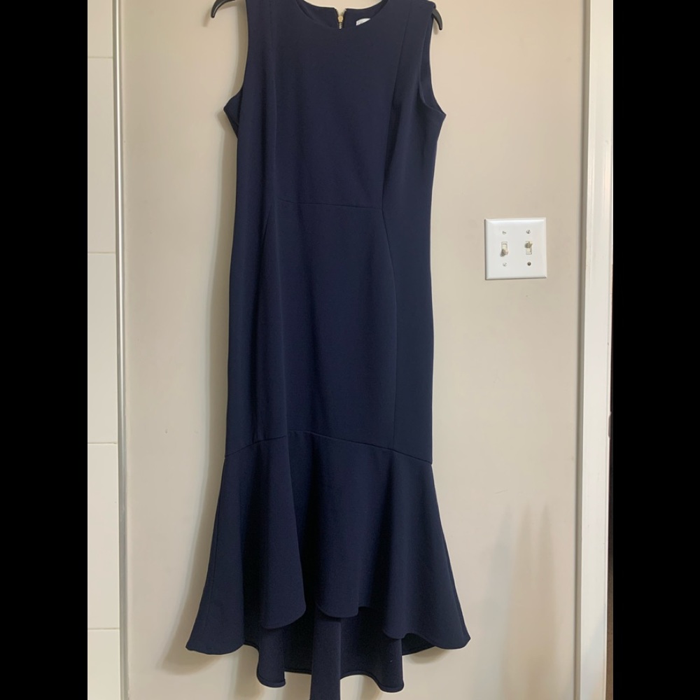 Form fitting with asymmetrical flair dress